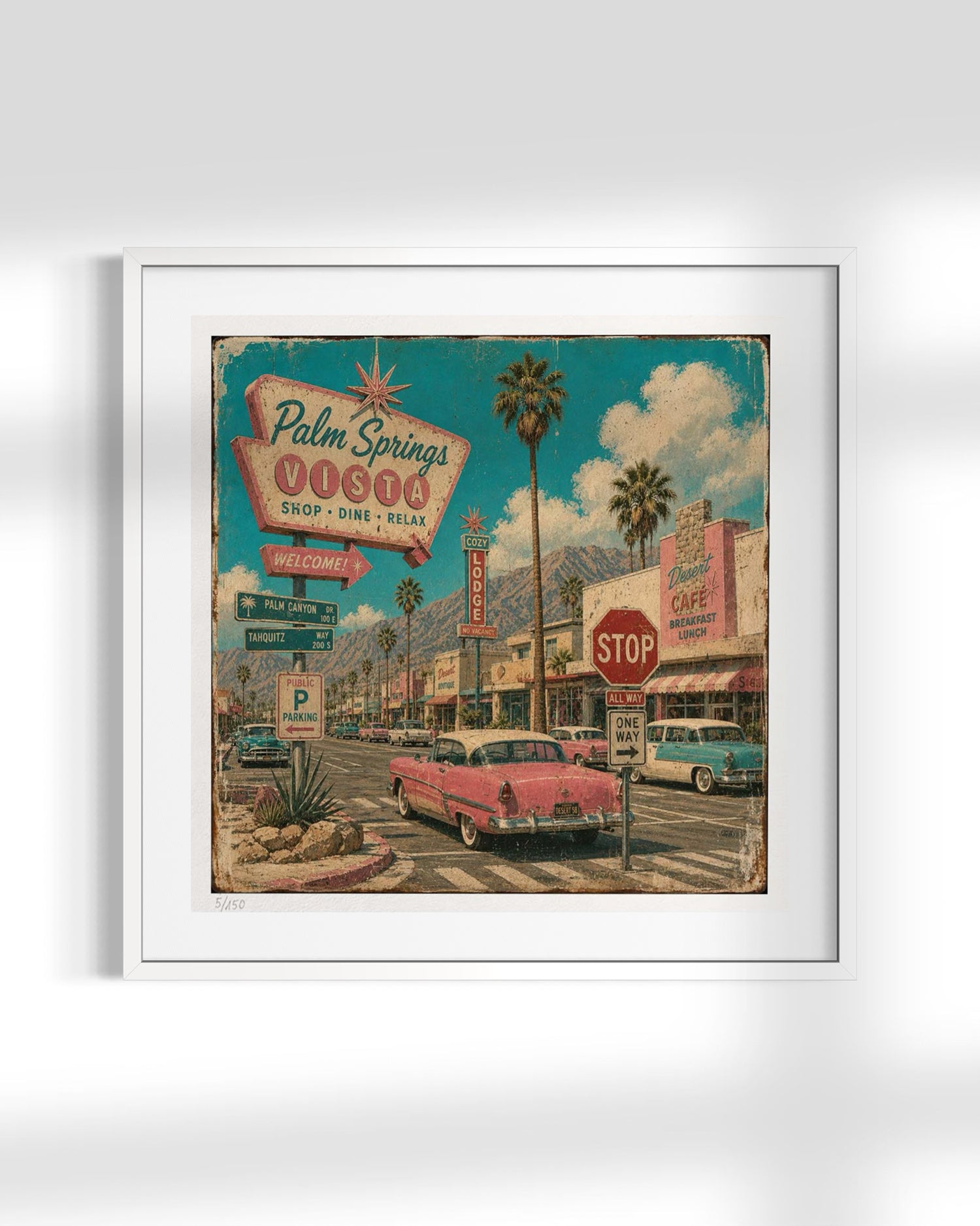 A framed vintage-style art print depicting a retro Palm Springs street scene with a pink car, palm trees, and signage, shown against a light gray background.