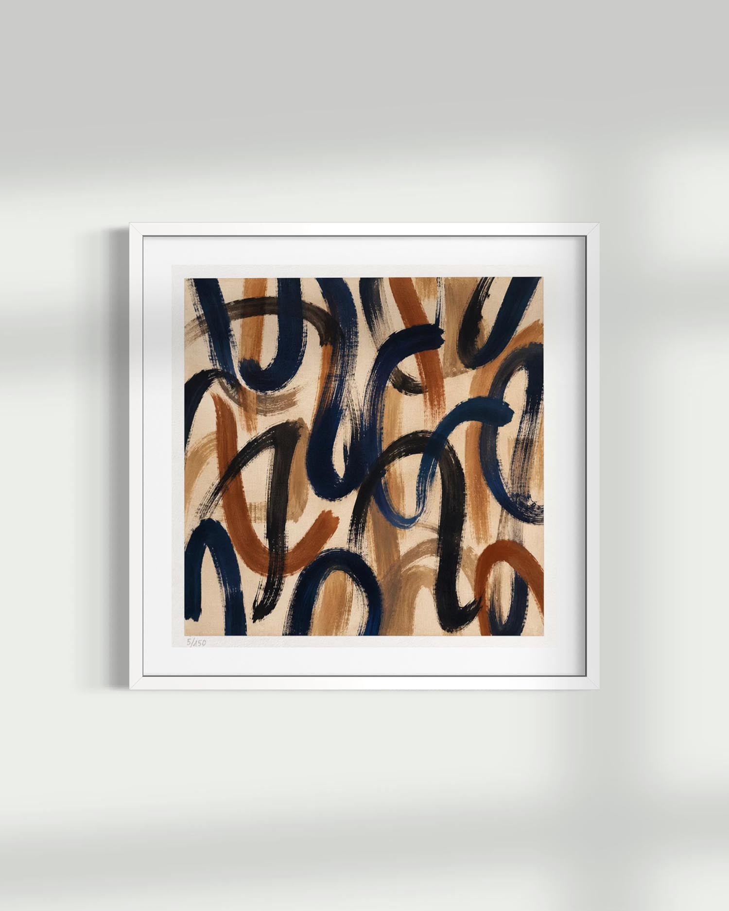 A framed abstract art print featuring organic, flowing brushstrokes in navy blue, terracotta, and tan on a white frame, displayed against a light gray wall with soft shadows.