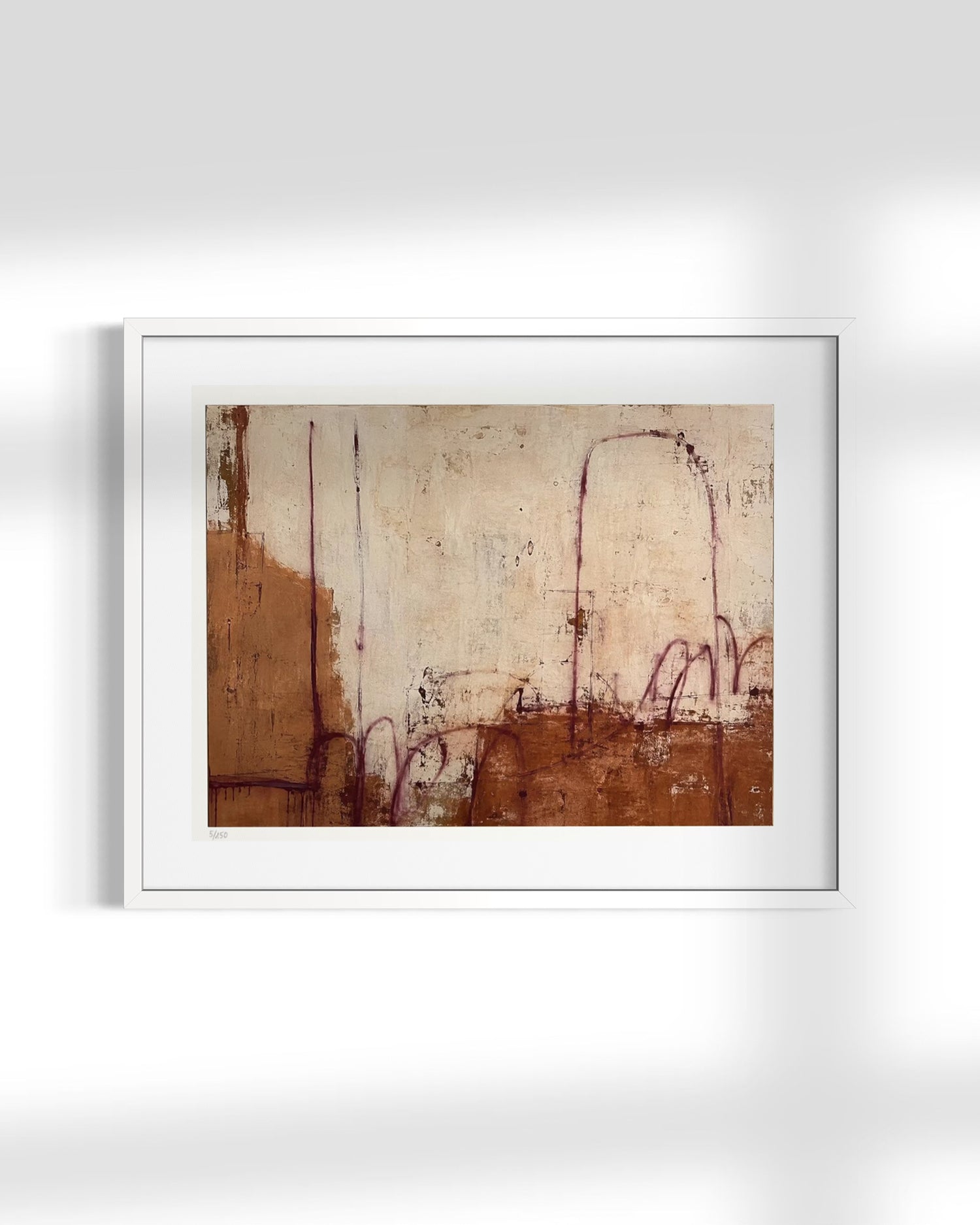 A framed abstract art print featuring earthy brown and beige tones with delicate reddish-purple line details, presented in a white frame against a light gray wall.