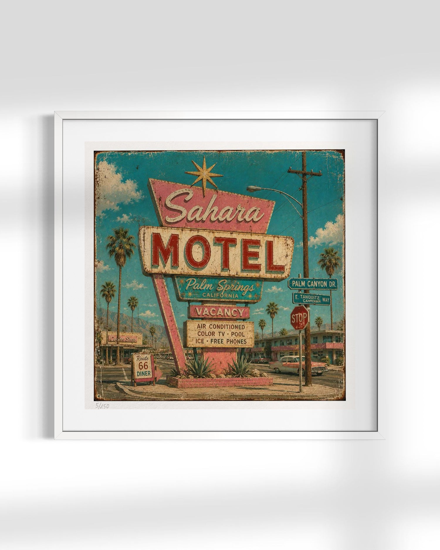 A framed vintage-style art print of the iconic Sahara Motel in Palm Springs, featuring a retro turquoise sky, palm trees, and a weathered neon sign, presented in a white frame against a light gray background.