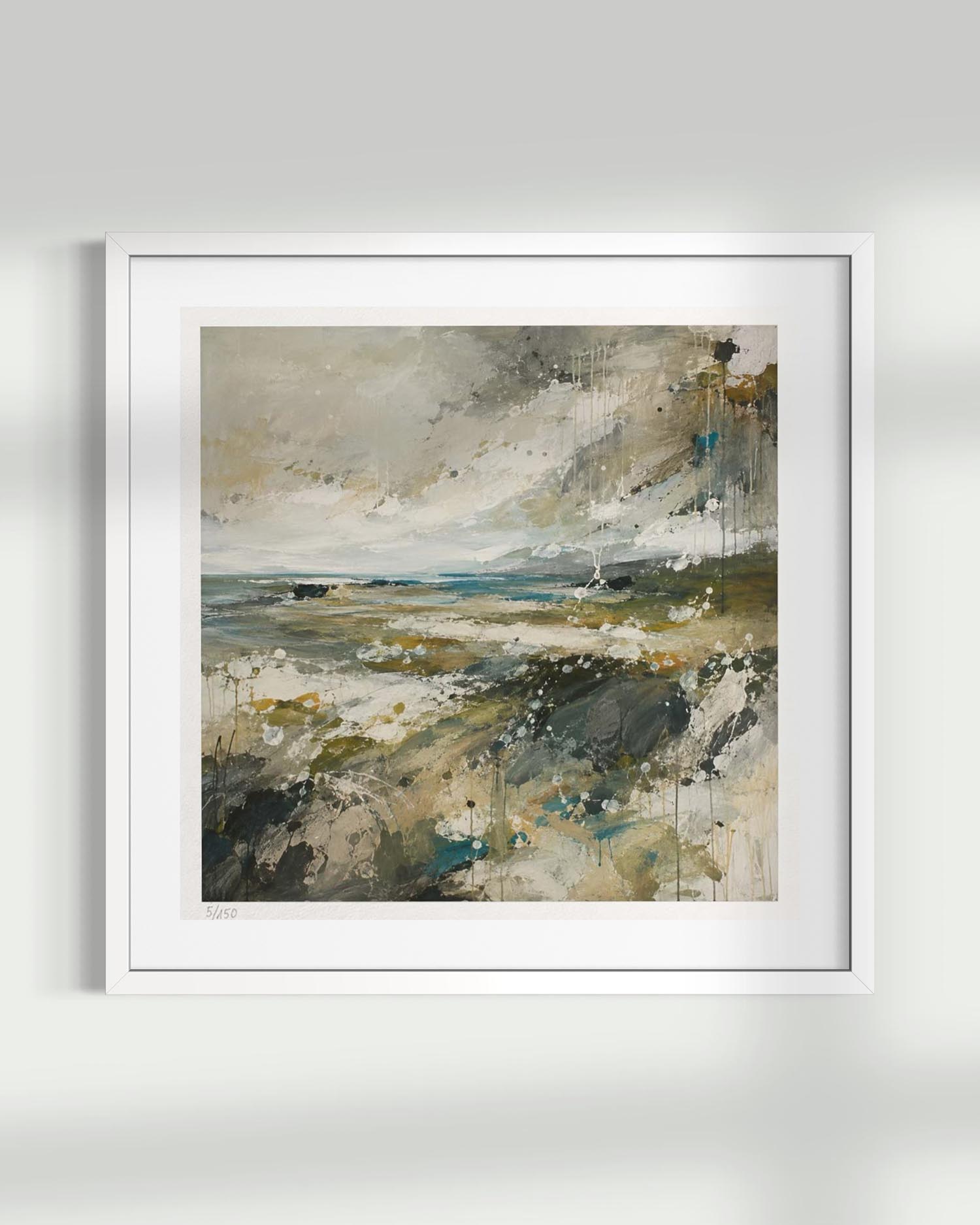 A framed abstract landscape painting featuring textured brushstrokes of beige, gray, olive green, and blue, presented in a white frame against a light gray wall.